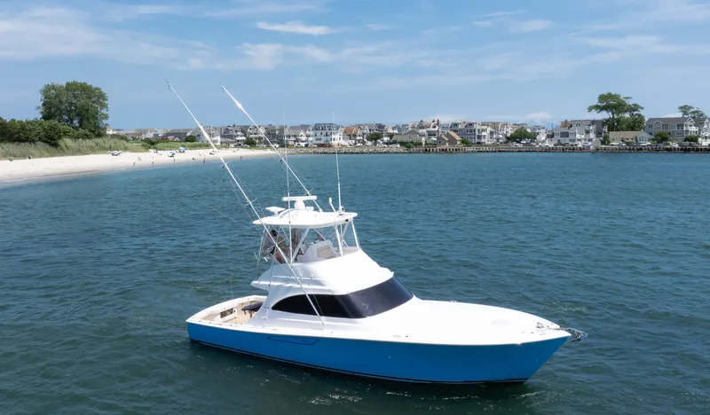 Stephanie Rose Yacht Photos Pics 2021 Viking 46 Billfish yacht cruising near a scenic coastal town.