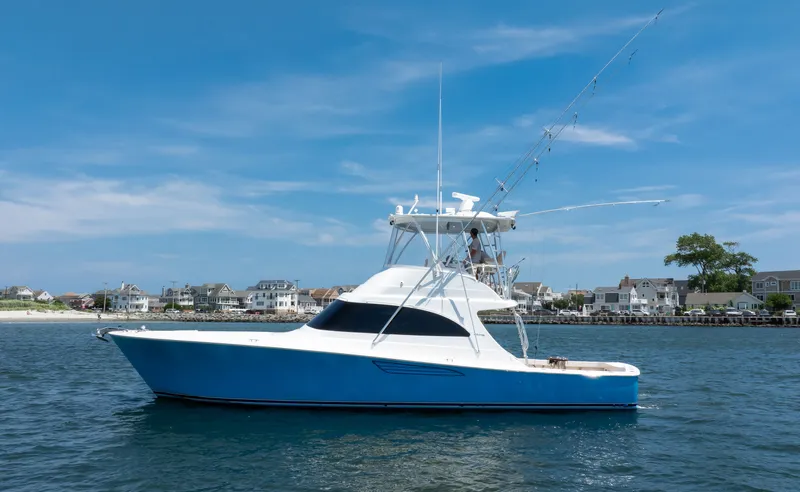Stephanie Rose Yacht Photos Pics 2021 Viking 46 Billfish yacht on water, blue hull, coastal background.