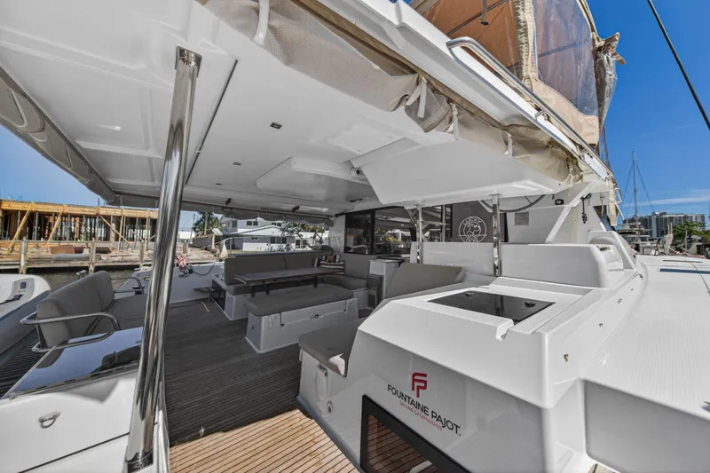 Lucky Dog Yacht Photos Pics 2022 Fountaine Pajot Tanna 47 yacht, spacious deck with seating and modern amenities.