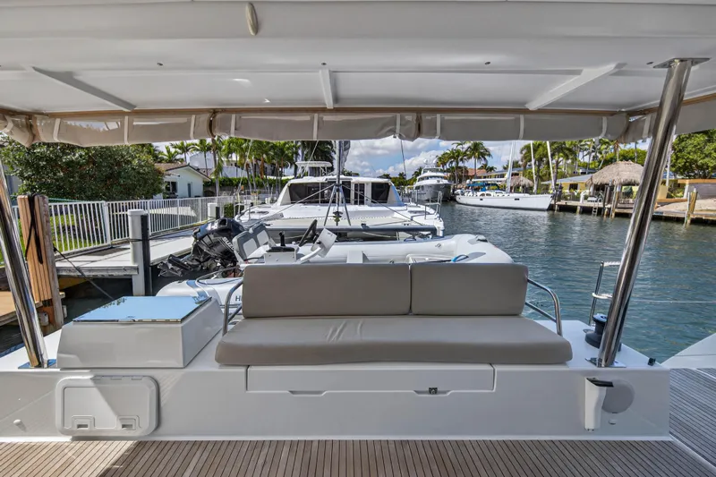 Lucky Dog Yacht Photos Pics 2022 Fountaine Pajot Tanna 47 yacht docked, featuring a spacious outdoor seating area.