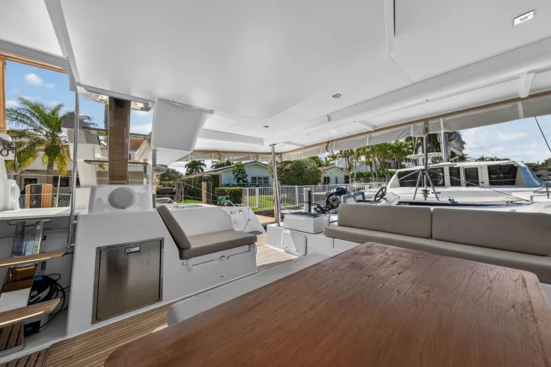 Lucky Dog Yacht Photos Pics 2022 Fountaine Pajot Tanna 47 yacht deck with seating and outdoor dining area.