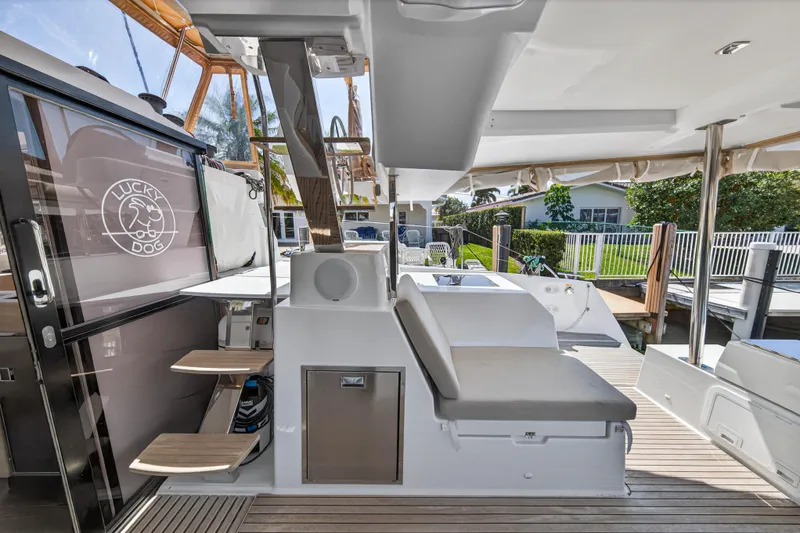 Lucky Dog Yacht Photos Pics 2022 Fountaine Pajot Tanna 47 yacht deck with seating and "Lucky Dog" logo.