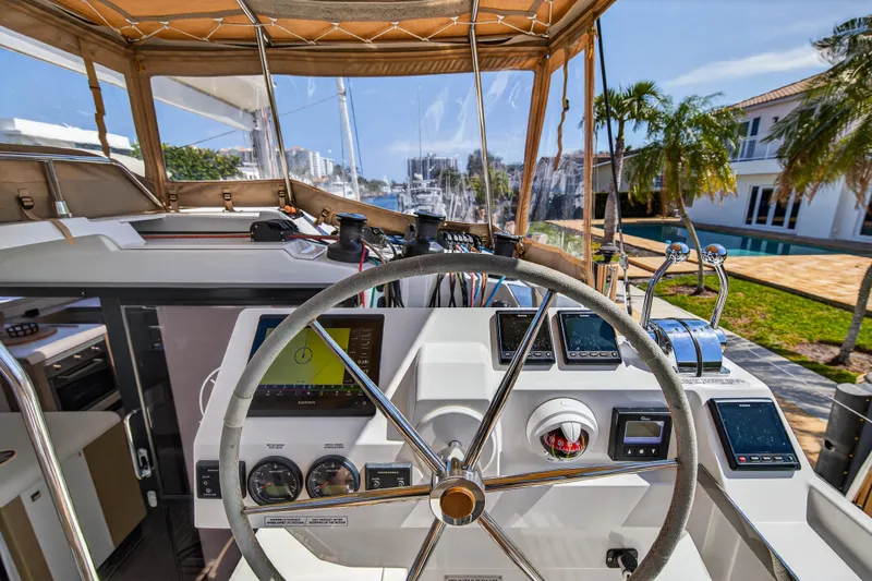 Lucky Dog Yacht Photos Pics Cockpit of 2022 Fountaine Pajot Tanna 47 catamaran with modern navigation instruments.