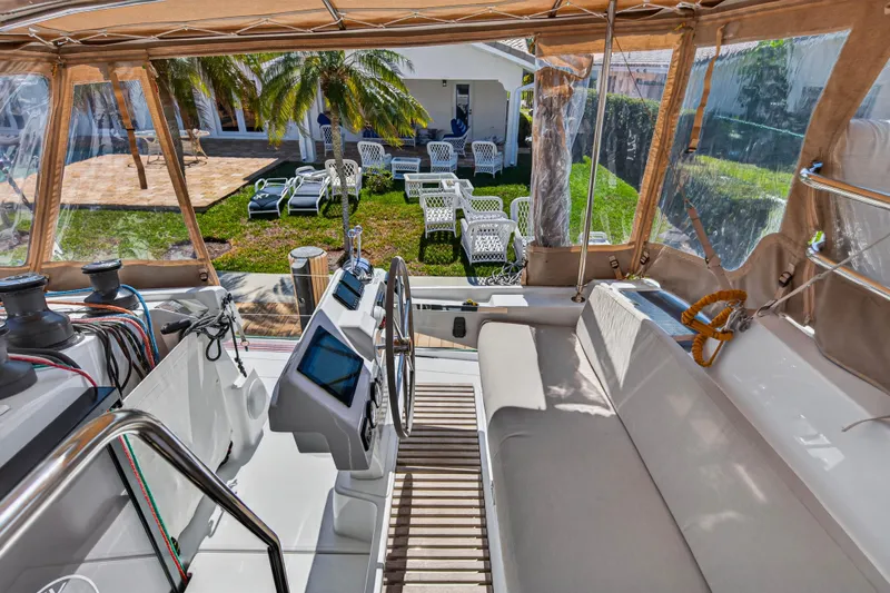 Lucky Dog Yacht Photos Pics 2022 Fountaine Pajot Tanna 47 yacht cockpit with helm, overlooking garden and patio.
