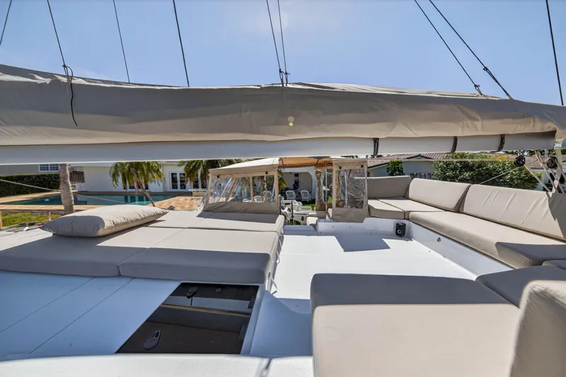 Lucky Dog Yacht Photos Pics Luxurious 2022 Fountaine Pajot Tanna 47 yacht deck with spacious seating and sunbathing area.