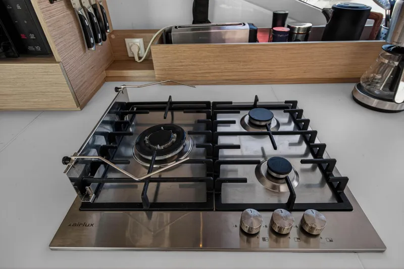 Lucky Dog Yacht Photos Pics Modern kitchen stove on 2022 Fountaine Pajot Tanna 47 yacht, featuring sleek design and functionality.
