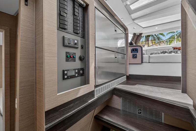 Lucky Dog Yacht Photos Pics Interior of 2022 Fountaine Pajot Tanna 47 yacht, featuring modern control panel and seating area.