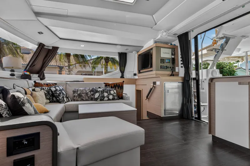 Lucky Dog Yacht Photos Pics Luxurious interior of 2022 Fountaine Pajot Tanna 47 catamaran with modern furnishings and elegant design.