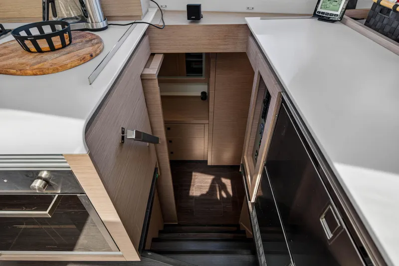 Lucky Dog Yacht Photos Pics Interior of 2022 Fountaine Pajot Tanna 47 yacht, featuring modern kitchen and staircase.