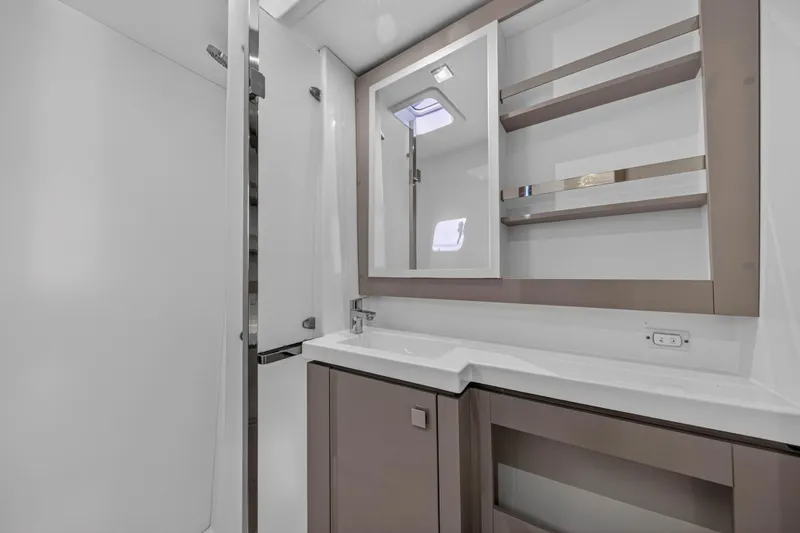 Lucky Dog Yacht Photos Pics Modern bathroom interior of 2022 Fountaine Pajot Tanna 47 yacht, featuring sleek design and storage.