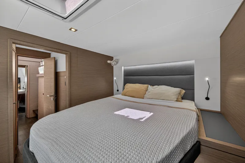 Lucky Dog Yacht Photos Pics Luxurious bedroom interior of 2022 Fountaine Pajot Tanna 47 yacht with modern design.