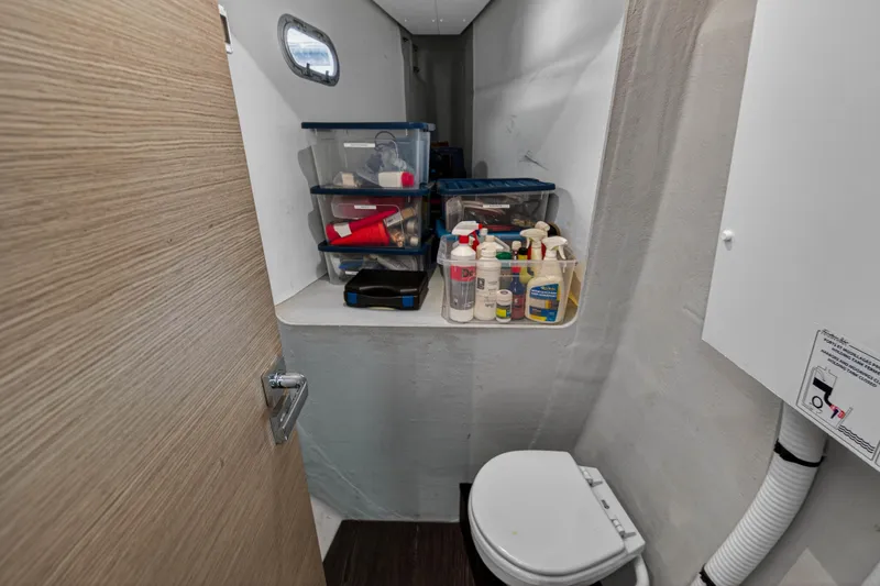Lucky Dog Yacht Photos Pics 2022 Fountaine Pajot Tanna 47 yacht bathroom with storage containers and toilet.