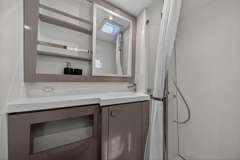 Lucky Dog Yacht Photos Pics Modern bathroom interior of 2022 Fountaine Pajot Tanna 47 yacht, featuring sleek design and fixtures.
