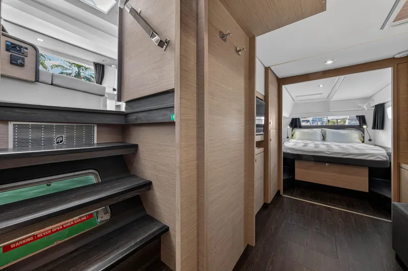 Lucky Dog Yacht Photos Pics Interior of 2022 Fountaine Pajot Tanna 47 yacht, featuring modern bedroom and staircase.
