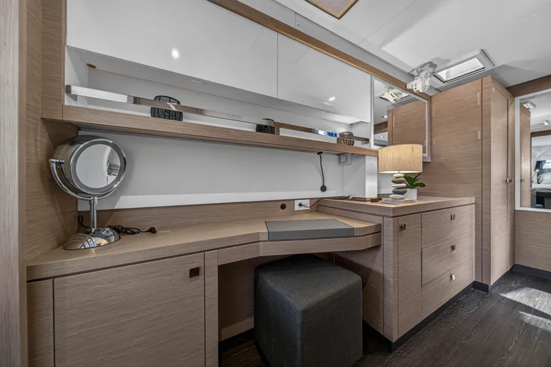 Lucky Dog Yacht Photos Pics Luxurious interior of 2022 Fountaine Pajot Tanna 47 yacht with modern vanity and storage.
