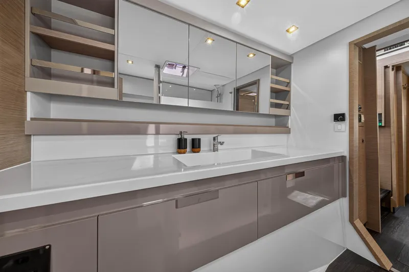 Lucky Dog Yacht Photos Pics Luxurious bathroom interior of 2022 Fountaine Pajot Tanna 47 yacht, featuring sleek design and modern fixtures.