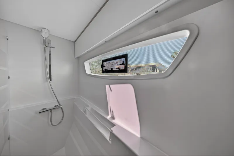 Lucky Dog Yacht Photos Pics Modern bathroom interior of 2022 Fountaine Pajot Tanna 47 yacht with shower and window.