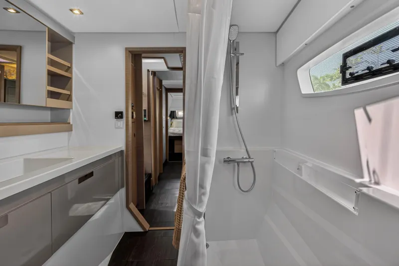 Lucky Dog Yacht Photos Pics Modern bathroom interior of 2022 Fountaine Pajot Tanna 47 yacht, featuring sleek design and shower.
