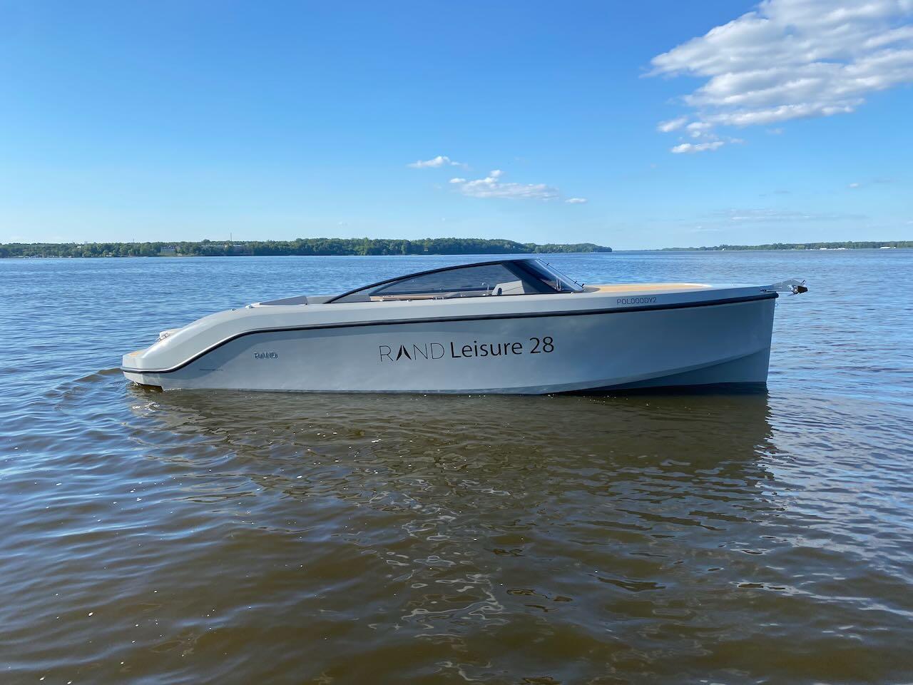 2021 Rand Leisure 28 boat on calm water under a clear sky.