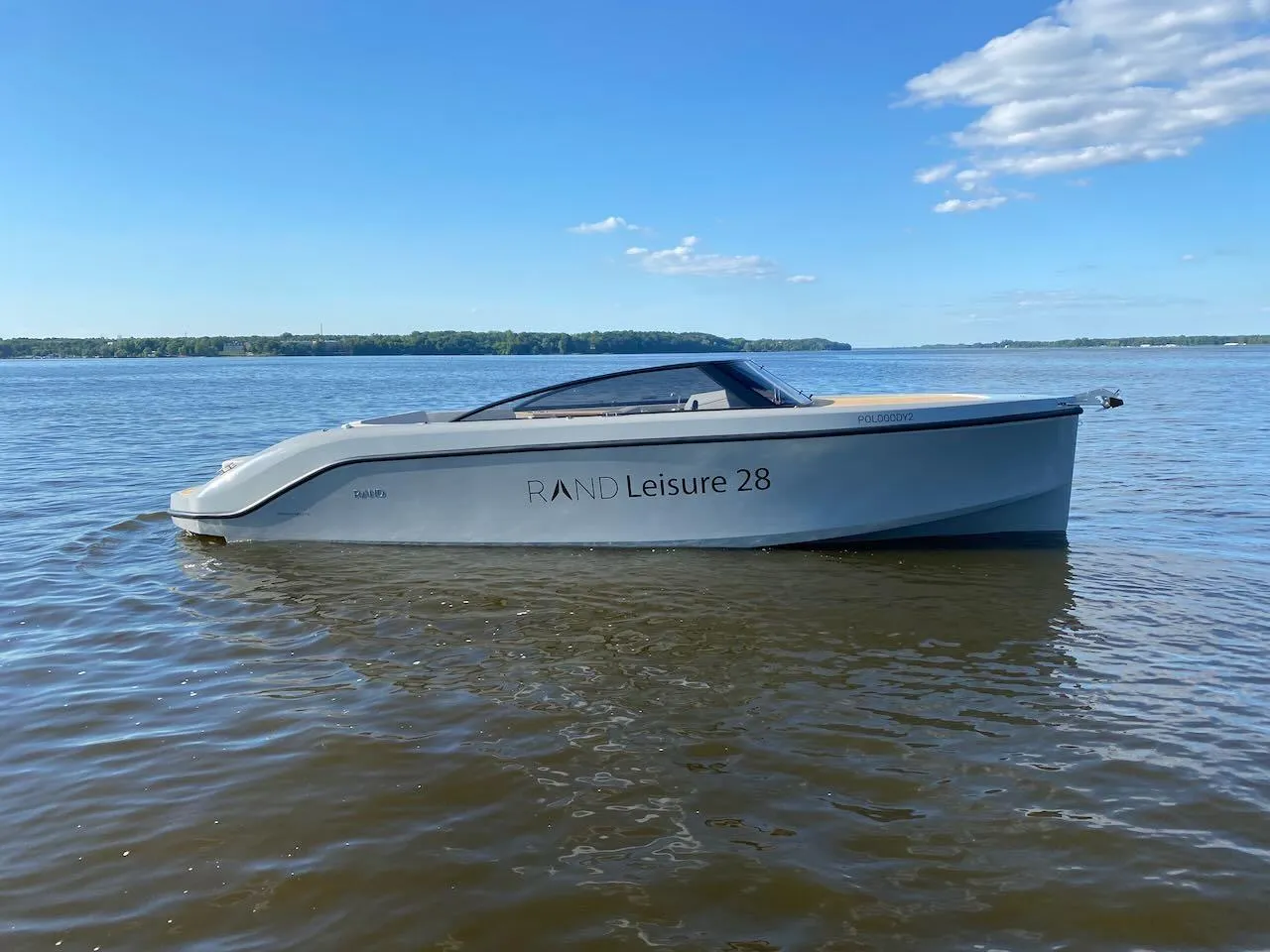 2021 Rand Leisure 28 boat on calm water under a clear sky.