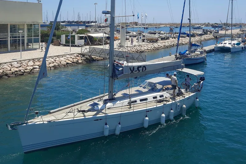  Yacht Photos Pics 2008 X-Yachts X50 sailboat docked in a sunny marina, surrounded by other boats.
