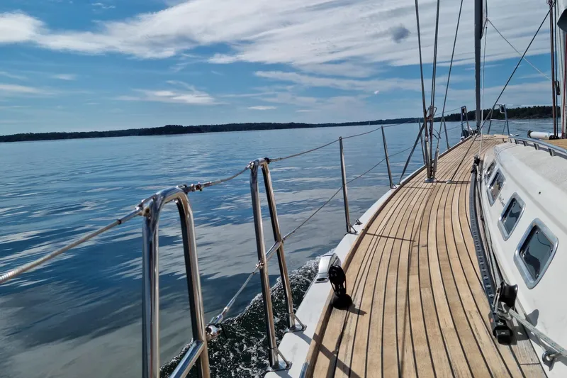  Yacht Photos Pics Sailing on a 2008 X-Yachts X50, calm waters, clear sky, wooden deck view.