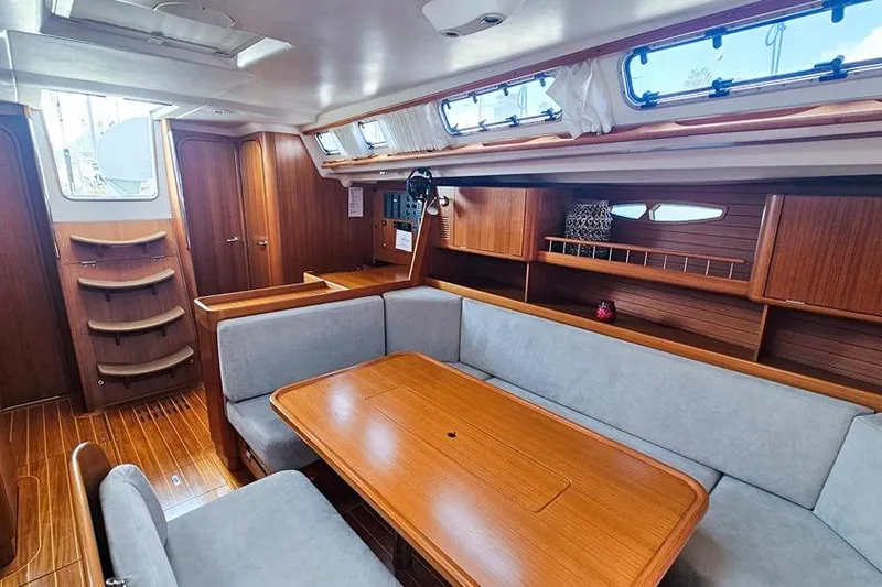  Yacht Photos Pics Luxurious interior of 2008 X-Yachts X50 sailboat with wooden furnishings and cozy seating.