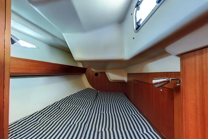  Yacht Photos Pics 2008 X-Yachts X50 cabin interior with striped bedding and wooden accents.