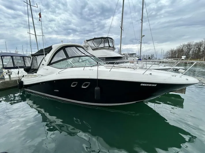  Yacht Photos Pics 2010 Sea Ray 330 Sundancer yacht docked in a marina under cloudy skies.