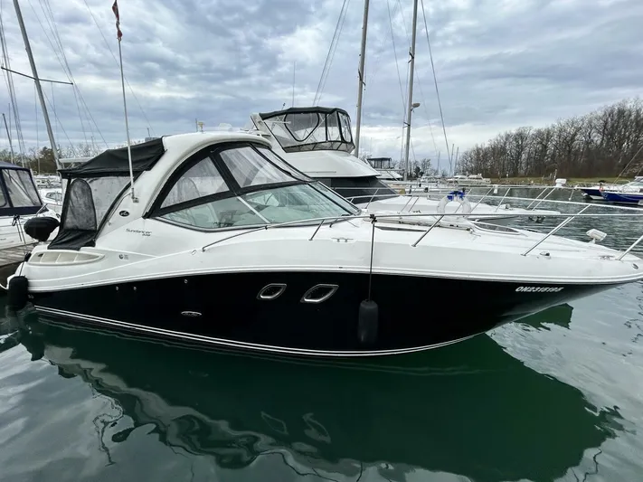  Yacht Photos Pics 2010 Sea Ray 330 Sundancer boat docked in marina, overcast sky.