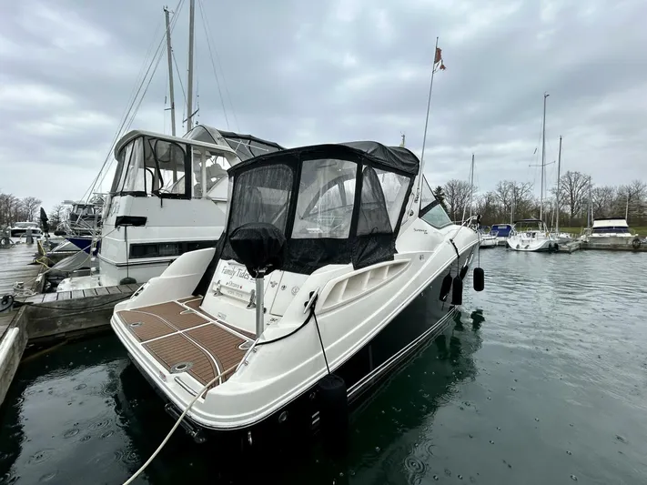  Yacht Photos Pics 2010 Sea Ray 330 Sundancer docked in a marina under cloudy skies.
