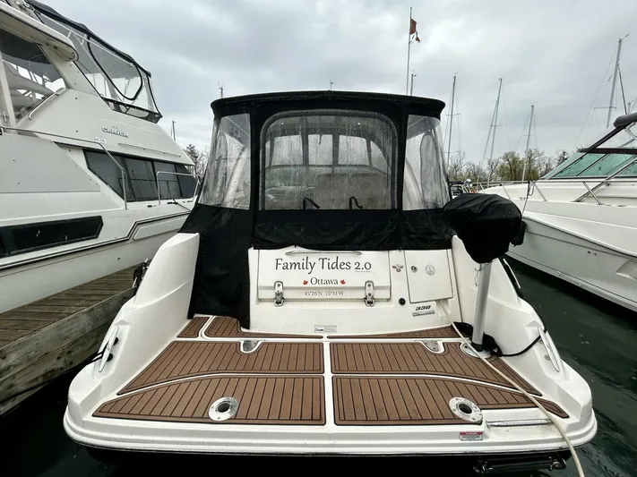  Yacht Photos Pics 2010 Sea Ray 330 Sundancer docked, featuring teak swim platform and black canvas cover.
