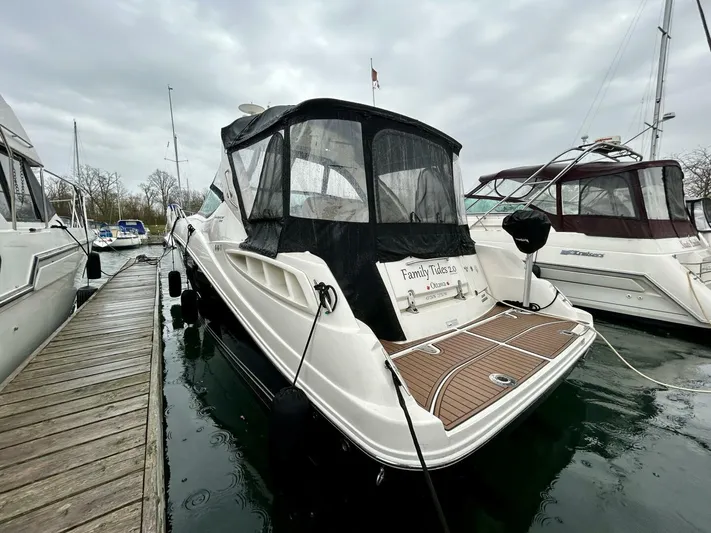  Yacht Photos Pics 2010 Sea Ray 330 Sundancer docked, featuring sleek design and covered cockpit.