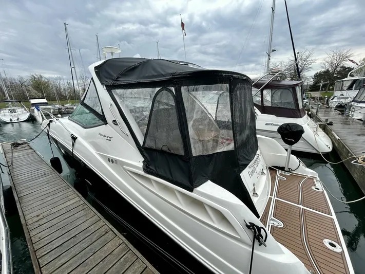  Yacht Photos Pics 2010 Sea Ray 330 Sundancer docked at marina under cloudy sky.