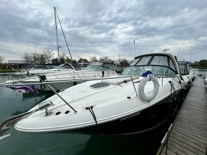  Yacht Photos Pics 2010 Sea Ray 330 Sundancer docked at marina under cloudy sky.