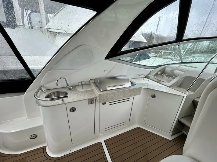  Yacht Photos Pics 2010 Sea Ray 330 Sundancer interior with kitchenette and seating area.