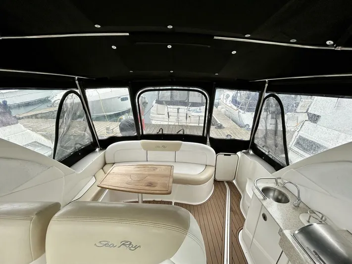  Yacht Photos Pics 2010 Sea Ray 330 Sundancer interior with seating, table, and kitchenette.