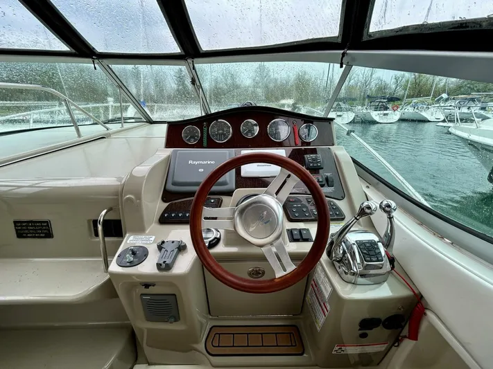  Yacht Photos Pics Cockpit of 2010 Sea Ray 330 Sundancer with steering wheel and navigation controls.