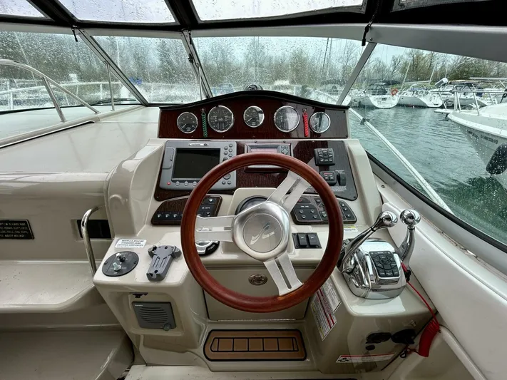  Yacht Photos Pics Helm of 2010 Sea Ray 330 Sundancer with steering wheel and control panel.
