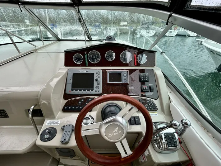  Yacht Photos Pics Cockpit of 2010 Sea Ray 330 Sundancer with steering wheel and navigation instruments.