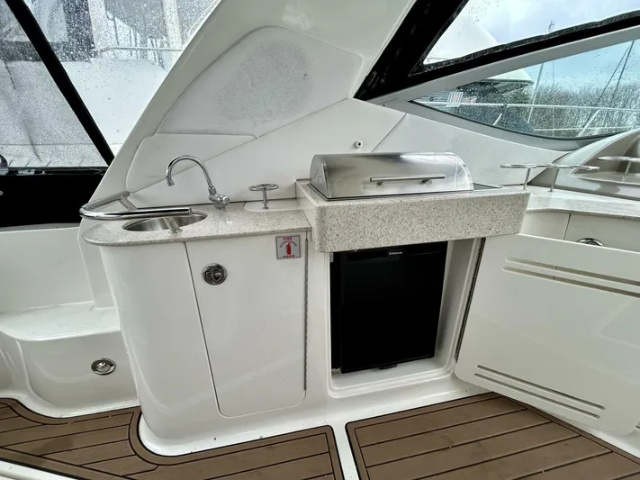  Yacht Photos Pics 2010 Sea Ray 330 Sundancer yacht interior with kitchenette, sink, and mini fridge.