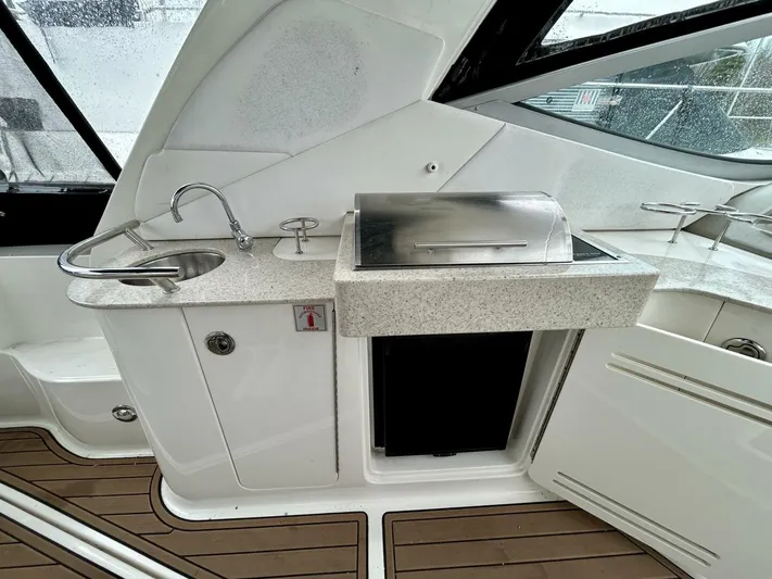 Yacht Photos Pics 2010 Sea Ray 330 Sundancer yacht kitchenette with sink, grill, and storage.