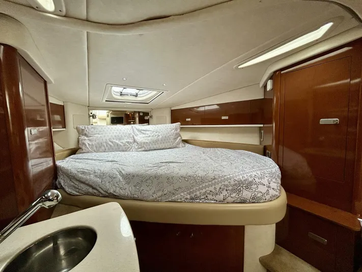  Yacht Photos Pics 2010 Sea Ray 330 Sundancer cabin with bed, wood paneling, and skylight.