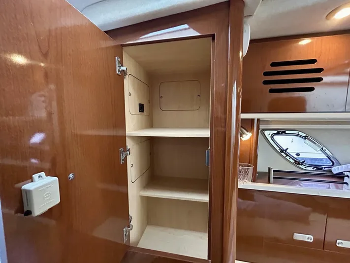  Yacht Photos Pics 2010 Sea Ray 330 Sundancer interior cabinet with open shelves and wood finish.