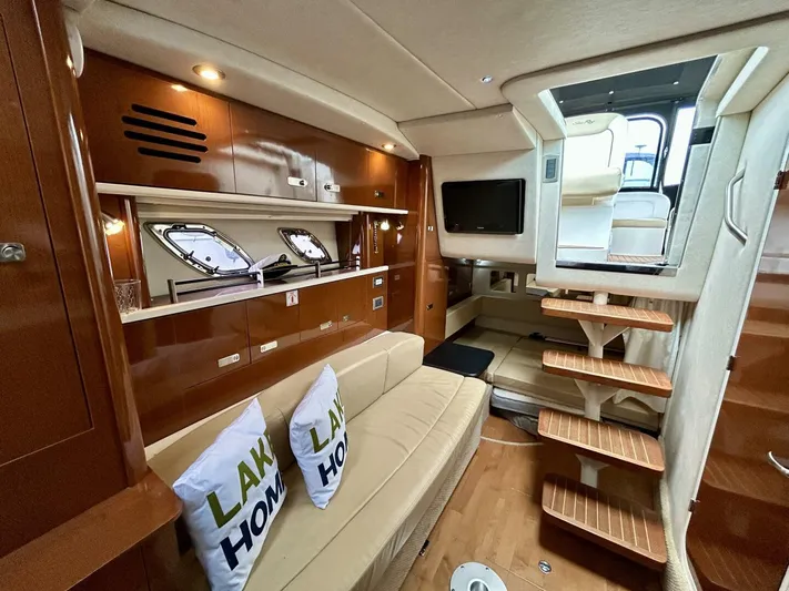  Yacht Photos Pics Interior of 2010 Sea Ray 330 Sundancer yacht with cozy seating and wooden accents.