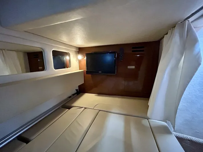  Yacht Photos Pics Interior cabin of 2010 Sea Ray 330 Sundancer with TV and beige seating.