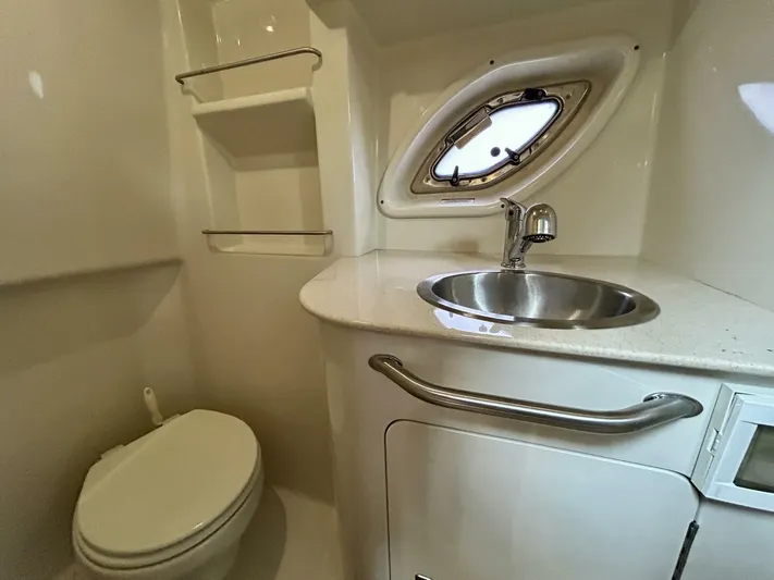  Yacht Photos Pics Bathroom interior of 2010 Sea Ray 330 Sundancer with sink, toilet, and porthole window.