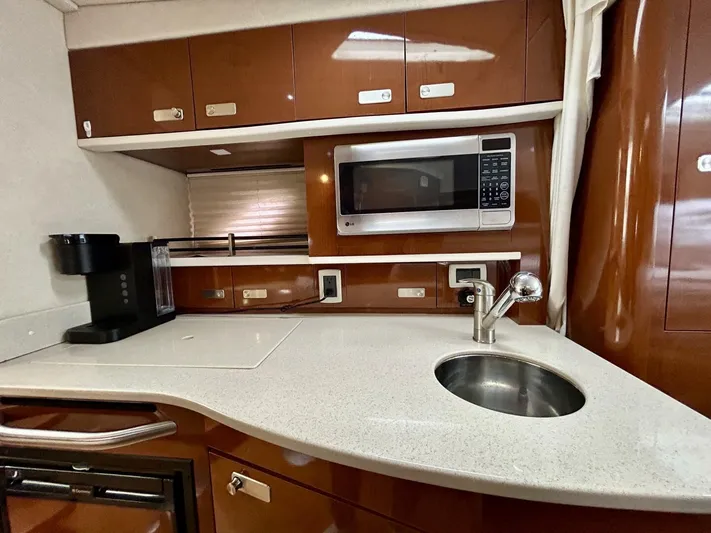  Yacht Photos Pics 2010 Sea Ray 330 Sundancer kitchen with microwave, sink, and coffee maker.