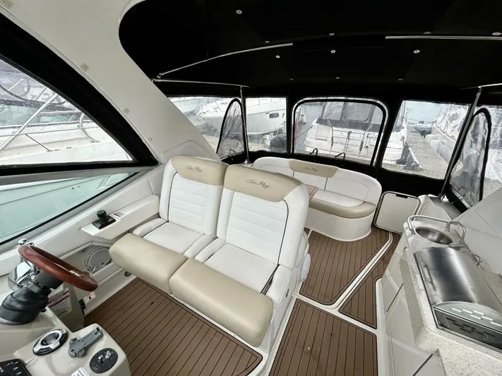  Yacht Photos Pics Interior of 2010 Sea Ray 330 Sundancer yacht with plush seating and helm.