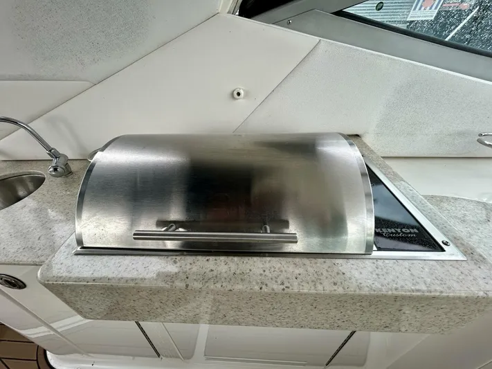  Yacht Photos Pics Outdoor grill on 2010 Sea Ray 330 Sundancer yacht, featuring stainless steel cover and sink.